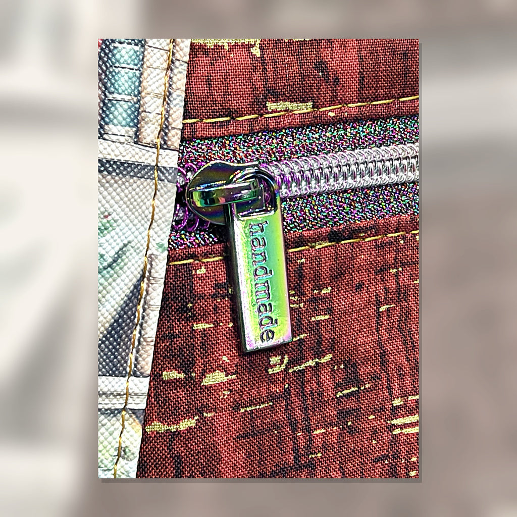 Close-up of handmade zipper pull and burgundy fabric on Book Nook Crossbody Bag
