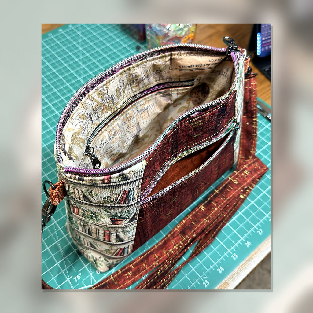 Book Nook Crossbody Bag open view showing interior organization and front zipper pocket